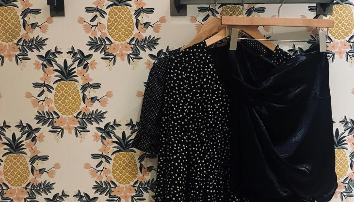 clothes hanging on a wall rack, pineapple wallpaper